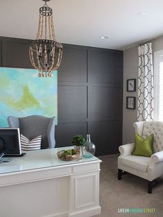 a living room filled with furniture and a chandelier hanging over the top of it