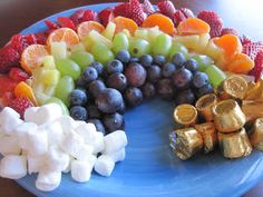 a blue plate topped with fruit and marshmallows