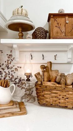 a kitchen shelf filled with lots of wooden utensils and other things on top of it