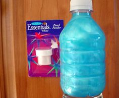 a blue water bottle sitting on top of a wooden cabinet next to a toothbrush