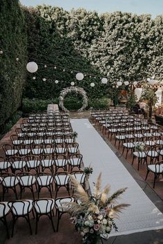 an outdoor ceremony setup with chairs and flowers