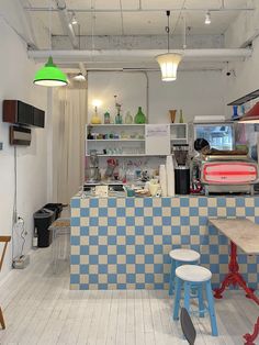 a kitchen with checkered tiles and stools next to a counter top in the center