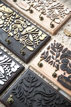 four different types of decorative wooden plaques on a table