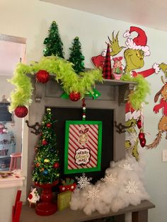 there is a fireplace decorated for christmas with dr seuss and grin the cat in the hat