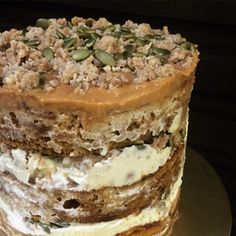 a close up of a cake with frosting and toppings on the top layer