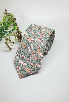 "I AM CURRENTLY AWAY FOR THE MONTH OF DECEMBER. YOU ARE WELCOME TO  PLACE YOUR ORDER, HOWEVER ALL ORDERS WILL BE SHIPPED OUT IN THE FIRST WEEK OF JANUARY. PLEASE FEEL FREE CONTACT ME IF YOU HAVE ANY QUESTIONS.Store Home Page - https://ivoryrosebridalau.etsy.com The Sage floral cotton Tie  is the perfect tie for the groom or groomsmen on their wedding day.  It features petite white, yellow and rust flowers on a sage green background. Matching Pocket square and Bow Tie is also available. Made  fro Wedding Cotton Suit And Tie Accessories, Cotton Wedding Suit And Tie Accessories, Green Tie For Wedding On Father's Day, Dapper Ties For Groom On Father's Day, Floral Print Standard Tie For Wedding, Wedding Suit Accessories With Floral Print Standard Tie, Floral Print Tie For Groom, Floral Print Standard Tie For Groom, Floral Print Ties For Groom