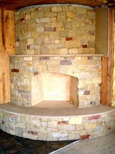 a stone fireplace in the corner of a room