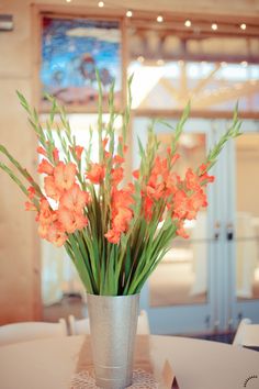 an arrangement of flowers in a vase on a table