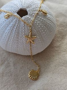 This is a Y shape gorgeous necklace for all beach lovers to express their love for ocean seashells! Dainty dangly cowrie shells, marine animals and starfish are such a site! Great gift for surfers, beach girls to scuba and freedivers to express their love for marine life! Such a flattering beach style to mix and match with other Kikita Jewelry pieces.  *18k gold-plated * gold-plated - length: 18 Inches +  *Adjustable length  *Lobster clasp closure   All Products are inspected for Quality 🤍To ex Sea Theme Jewelry, Gold Ocean Jewelry, Beach Girl Jewelry, Beach Accessories Jewelry, Gold Beach Jewelry, Summer Necklace Beach, Summer Jewelry Beach, Starfish Jewelry, Coastal Jewelry