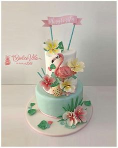 a three tiered cake decorated with flowers and a flamingo on the top layer