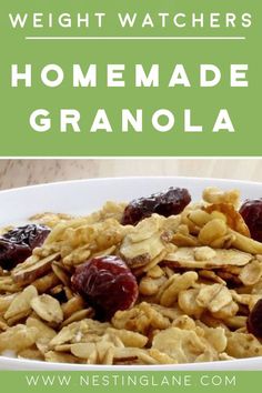 homemade granola with cranberries and raisins in a white bowl on a wooden table