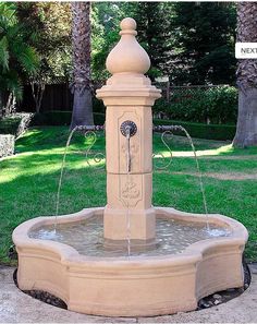 a water fountain in the middle of a park