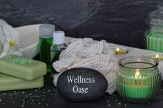 candles, soaps and other items are on a table next to each other with the words wellness case written on it