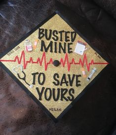 a graduation cap that says busted mine to save yours