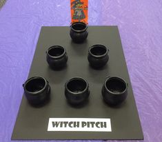 black cups sitting on top of a purple table