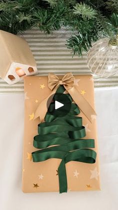 a present wrapped in brown paper with a green ribbon