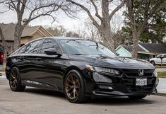 a black car parked in front of a house