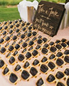 a table topped with lots of glasses next to a sign that says take a date