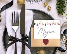 a place setting with silverware and christmas decorations