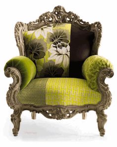 an ornate chair with green and black pillows