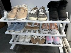 several pairs of shoes are lined up on a white shelve with fur lining the sides