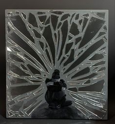 a glass block with an image of a person sitting in front of it