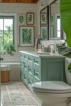 a white toilet sitting next to a bath tub in a bathroom filled with green plants