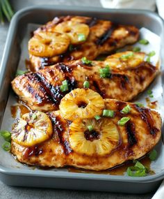 grilled chicken with pineapples and onions on a tray