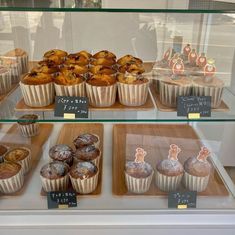 several different types of baked goods on display in a glass case