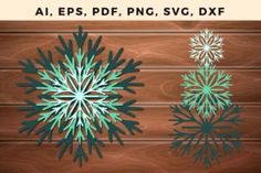 three snowflakes are shown on a wooden surface, one is green and the other is blue