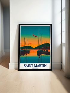 there is a framed poster on the wall next to a window that says saint martin