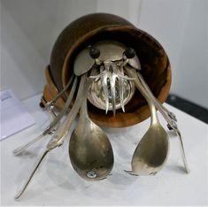 spoons and forks are on display in a bowl