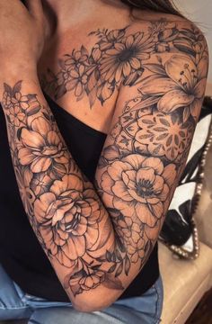 a woman's arm with flowers on it