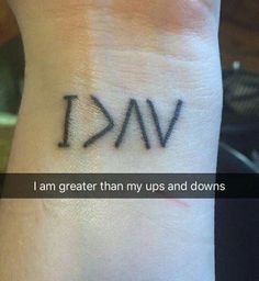 a wrist tattoo with the words i am greater than my ups and downs