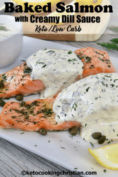 baked salmon with creamy dill sauce on a white plate