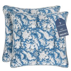 two blue and white floral pillows with price tag on each pillow, both in different sizes