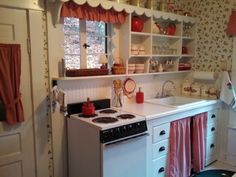 a kitchen with a stove top oven next to a window