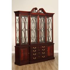 a wooden china cabinet with glass doors and drawers on the front, sitting on a hard wood floor