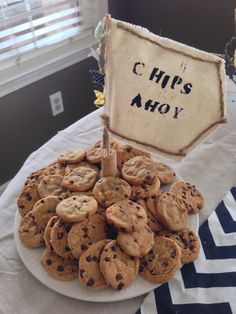 a plate full of cookies on a table with a sign that says chips ahoy