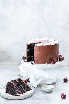 a chocolate cake with cherries on the side