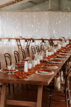 the tables are set up with place settings and napkins for guests to sit at