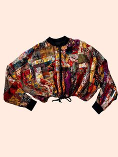 Introducing our one-of-a-kind bomber crop jacket, crafted with meticulous care and creativity. This stunning piece is made using the ancient art of patchwork, where various sizes of high-quality viscose fabric pieces are carefully cut and combined to create a unique and cohesive textile. The result is a vibrant, textured jacket that is not only a fashion statement but also a work of art. Details: - Material: 100% premium viscose fabric. - Technique: Handcrafted patchwork, ensuring each jacket is