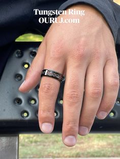 a close up of a person's hand with a wedding ring on their finger