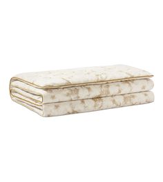 three mattresses stacked on top of each other in front of a white background with gold trim