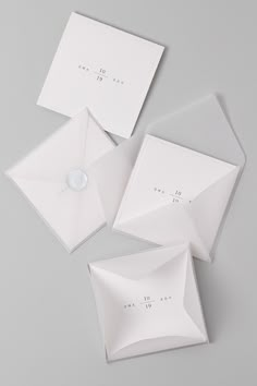 three white envelopes sitting on top of each other