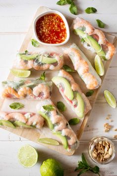 shrimp and avocado sushi on a cutting board with dipping sauce