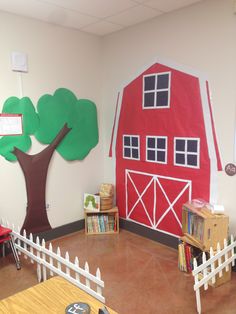 a room with a red barn and tree on the wall