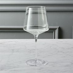 a wine glass sitting on top of a table