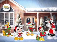 mickey mouse christmas yard decorations in front of a house