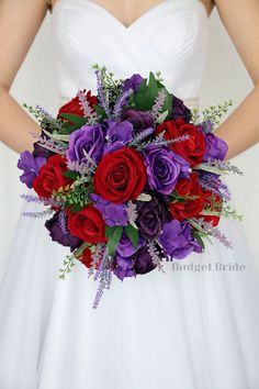 a bride holding a purple and red bouquet